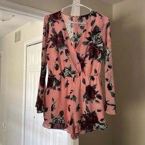 Pink floral long sleeve romper from Forever 21. Size small NWOT. Never worn!